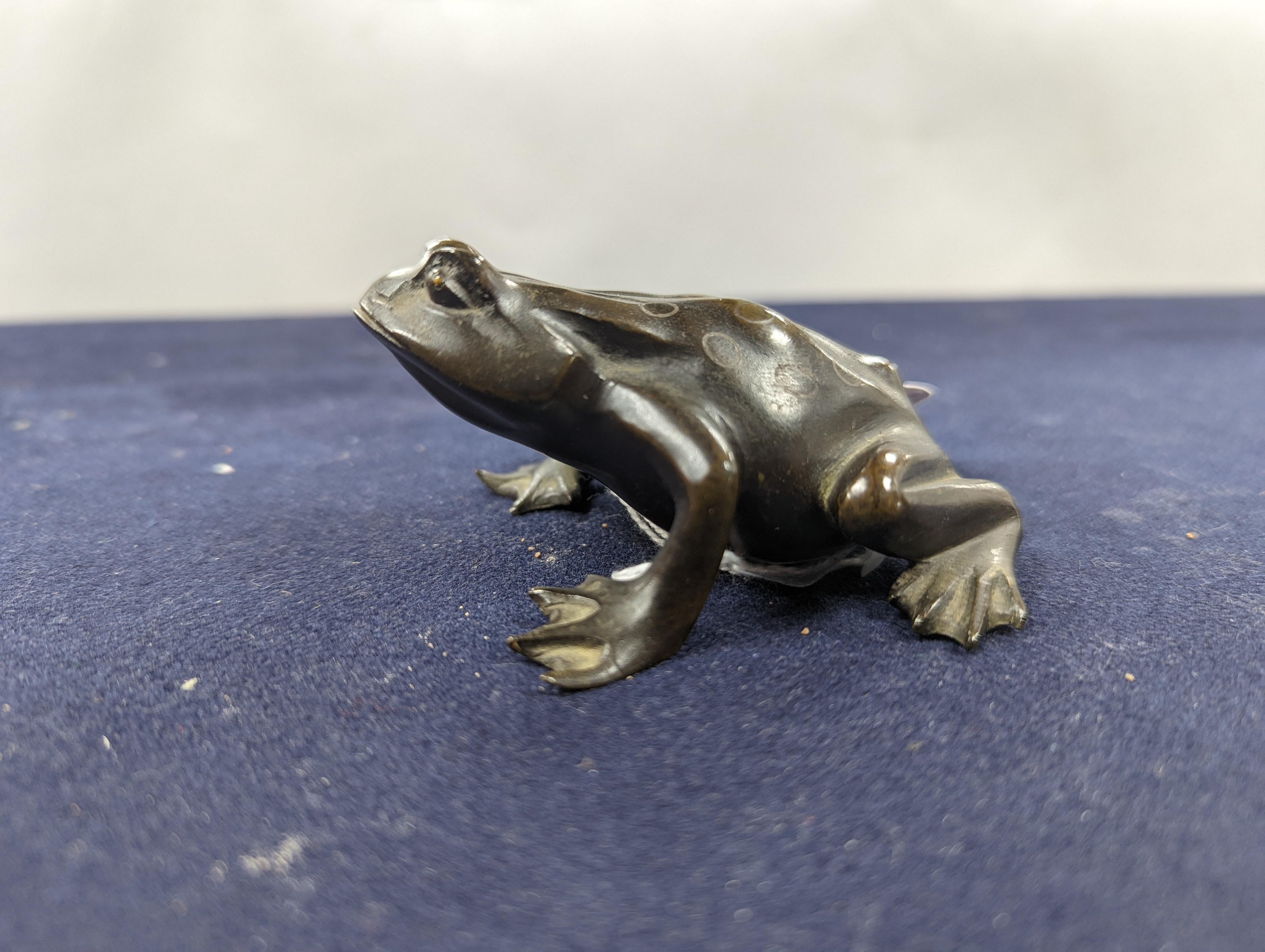 A Chinese bronze group of Liu Hai and a toad, wood stand and a bronze figure of a dog, 9cm